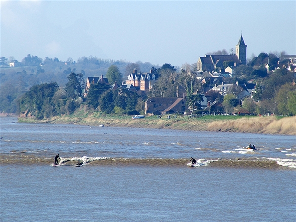 Surfers riding the Severn Bore at Newnham-on-Severn