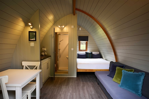 Inside a Mega Pod Premier at Whitemead Forest Park – stylish comfort with a cosy woodland feel.