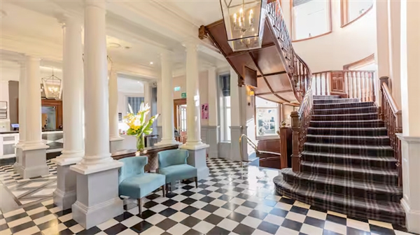 The elegant Georgian entrance hall, blending period architecture with modern luxury.