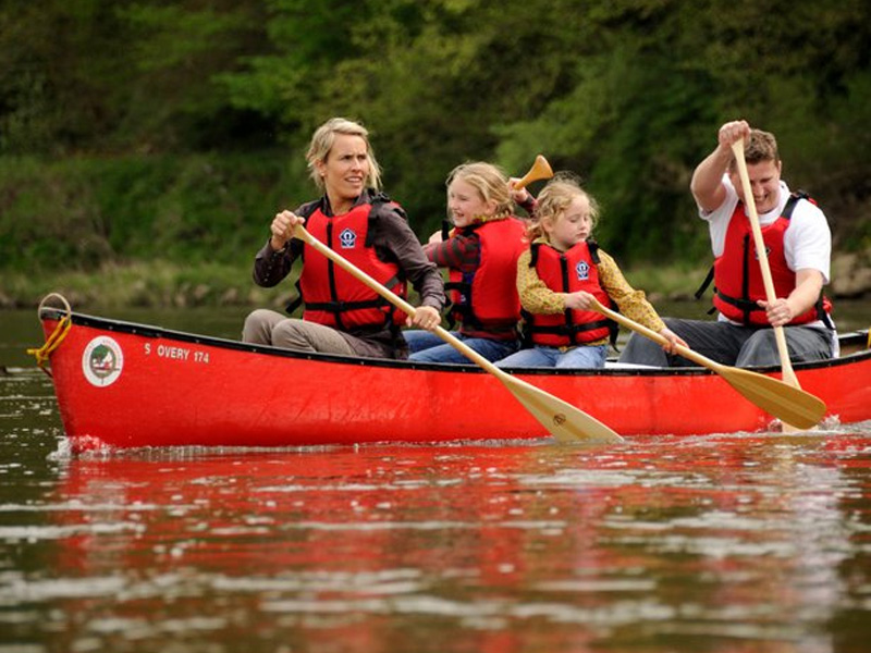 Family canoeing on the River Wye with Forest Adventure